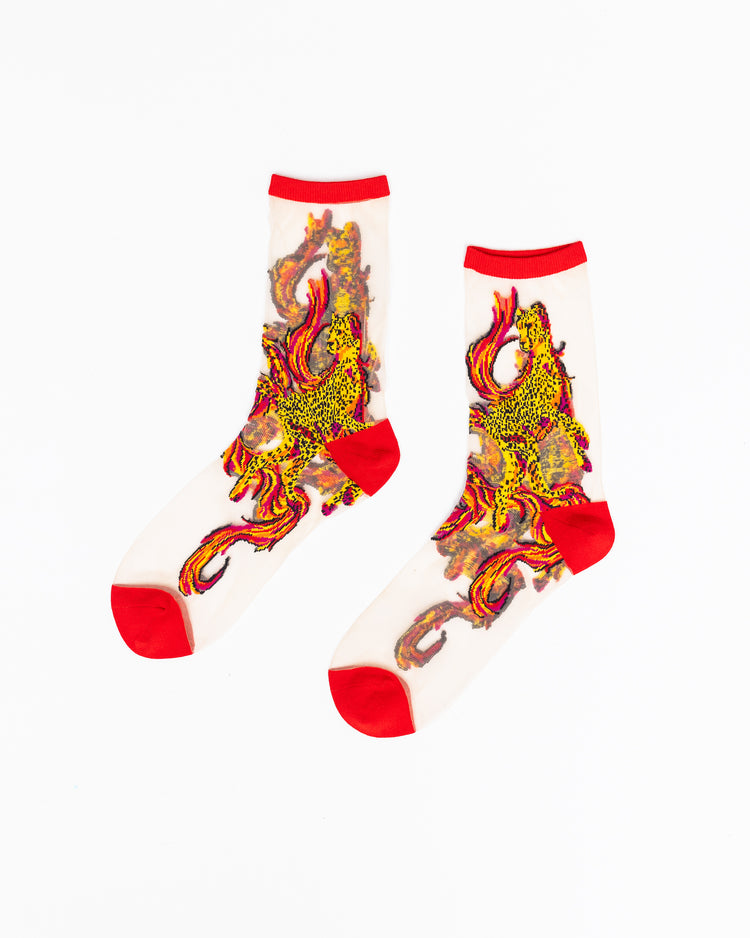 A pair of sheer Sock Candy socks with cheetah and flames design on a white background.