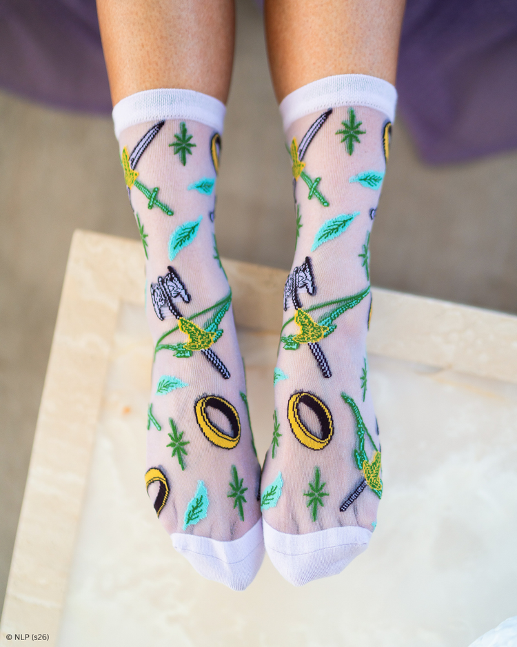 Women's legs wearing a pair of sheer Sock Candy socks featuring a Lord of the Rings motif.