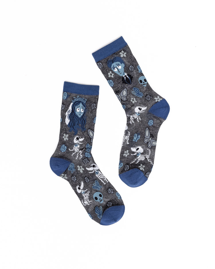 A pair of sheer Sock Candy socks with a  featuring characters and motifs from Tim Burton's The Corpse Bride on a white background.